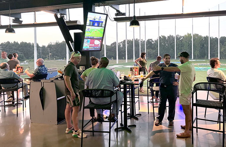 Dentists sitting at Top Golf networking.