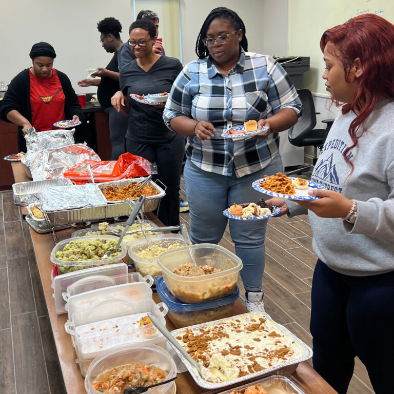 R-Dent employees waiting in the Thanksgiving potluck line