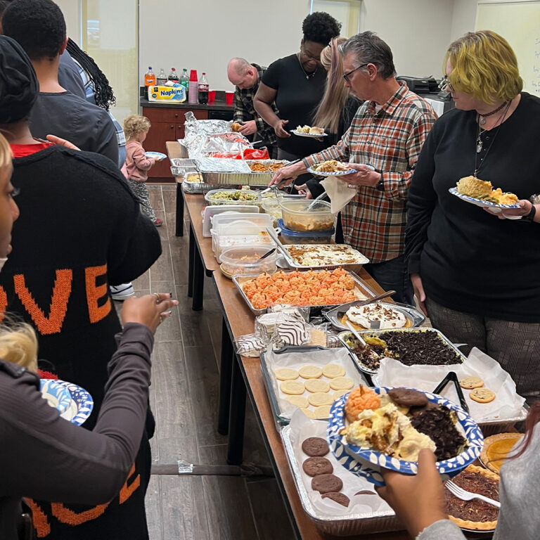 R-Dent employees waiting in the Thanksgiving potluck line