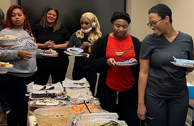 R-Dent employees waiting in the Thanksgiving potluck line